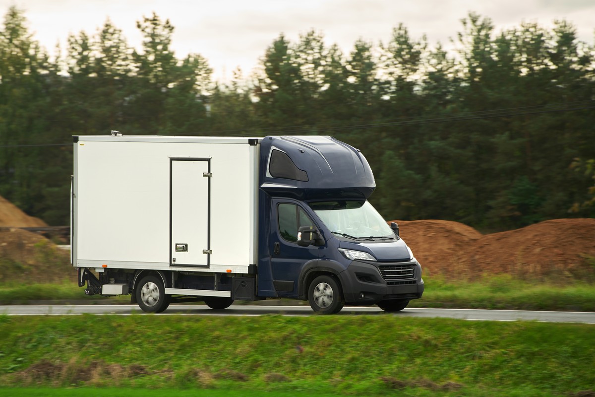 Commercial van on the road. Delivery van close-up mockup isolated. Final destination shipping truck mock-up.